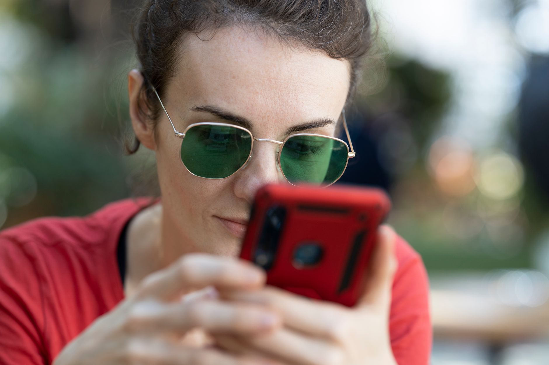 Person checking app permission settings on a smartphone with a focused expression.